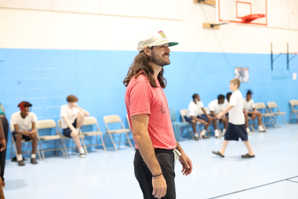 share ONE love volunteer leading sport programming in a gymnasium